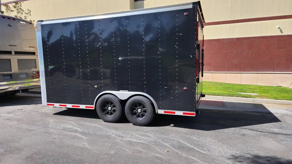 Enclosed tandem axle trailer parked on a lot